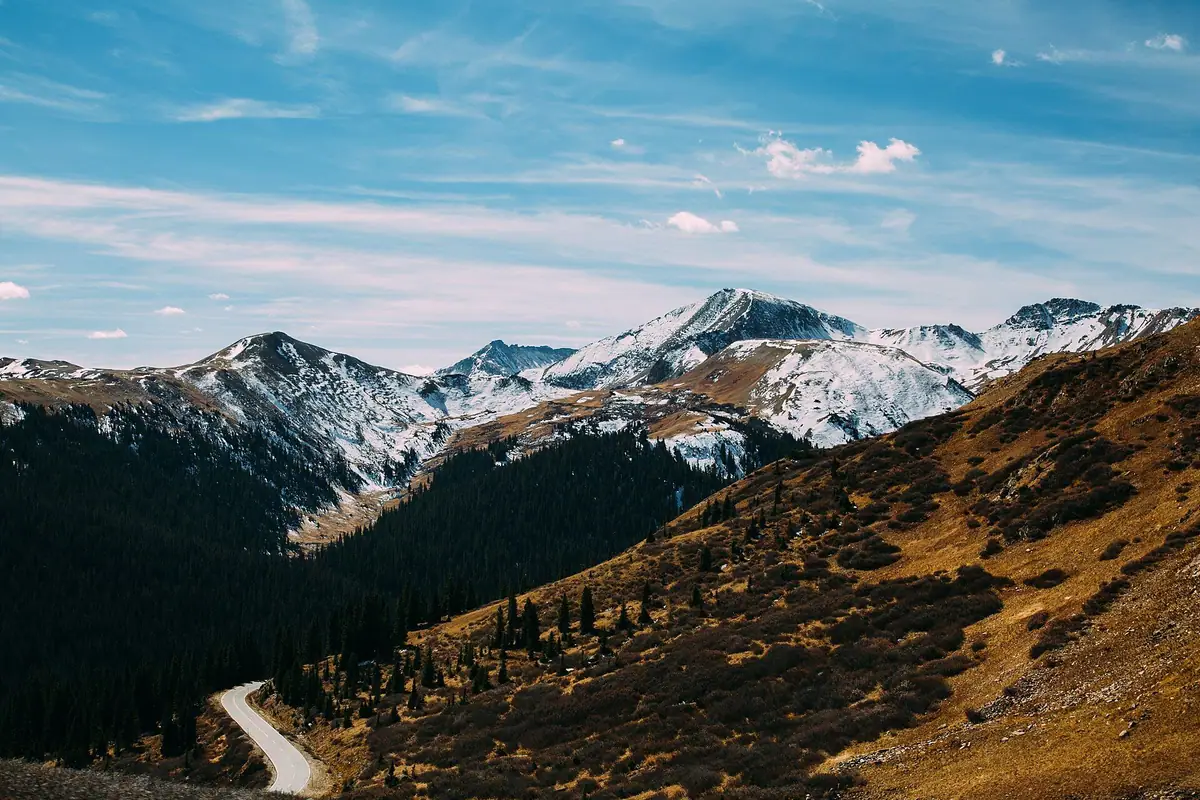 Mountain road winding through autumn hillsides near Aspen, Colorado