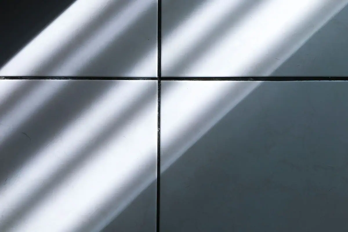 Morning light falling across dark tile and clean grout lines